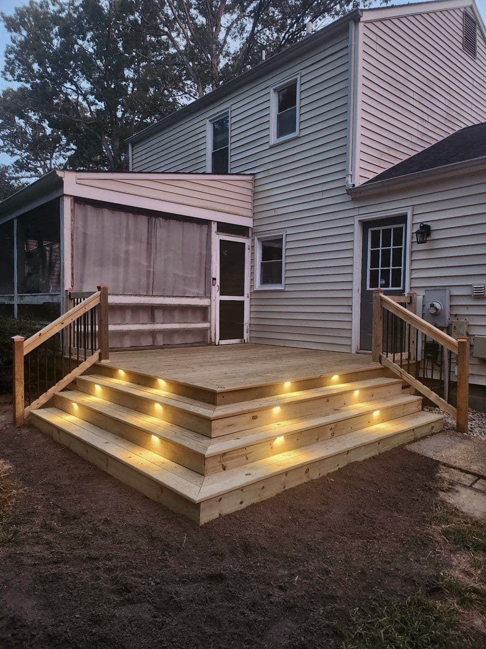 Stunning Deck with Cascade Stairs and Lighting image